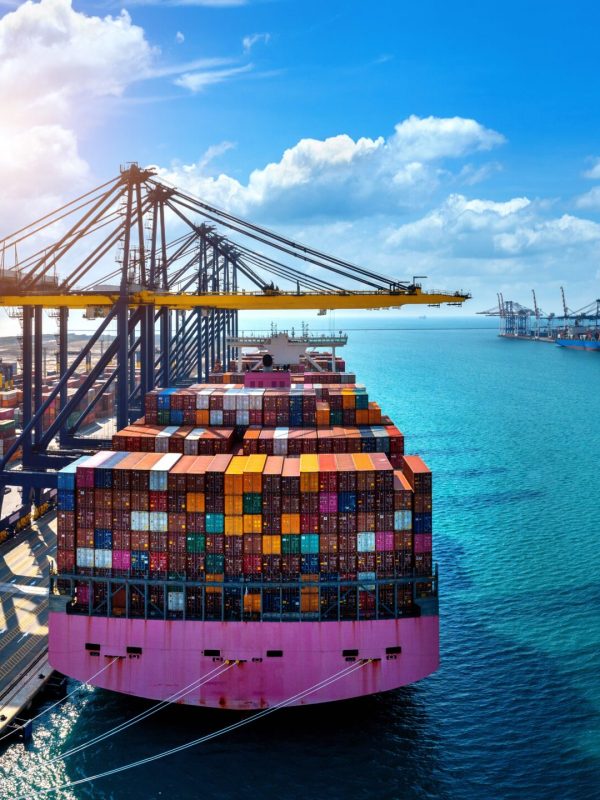 Aerial view of cargo ship and cargo container in harbor.